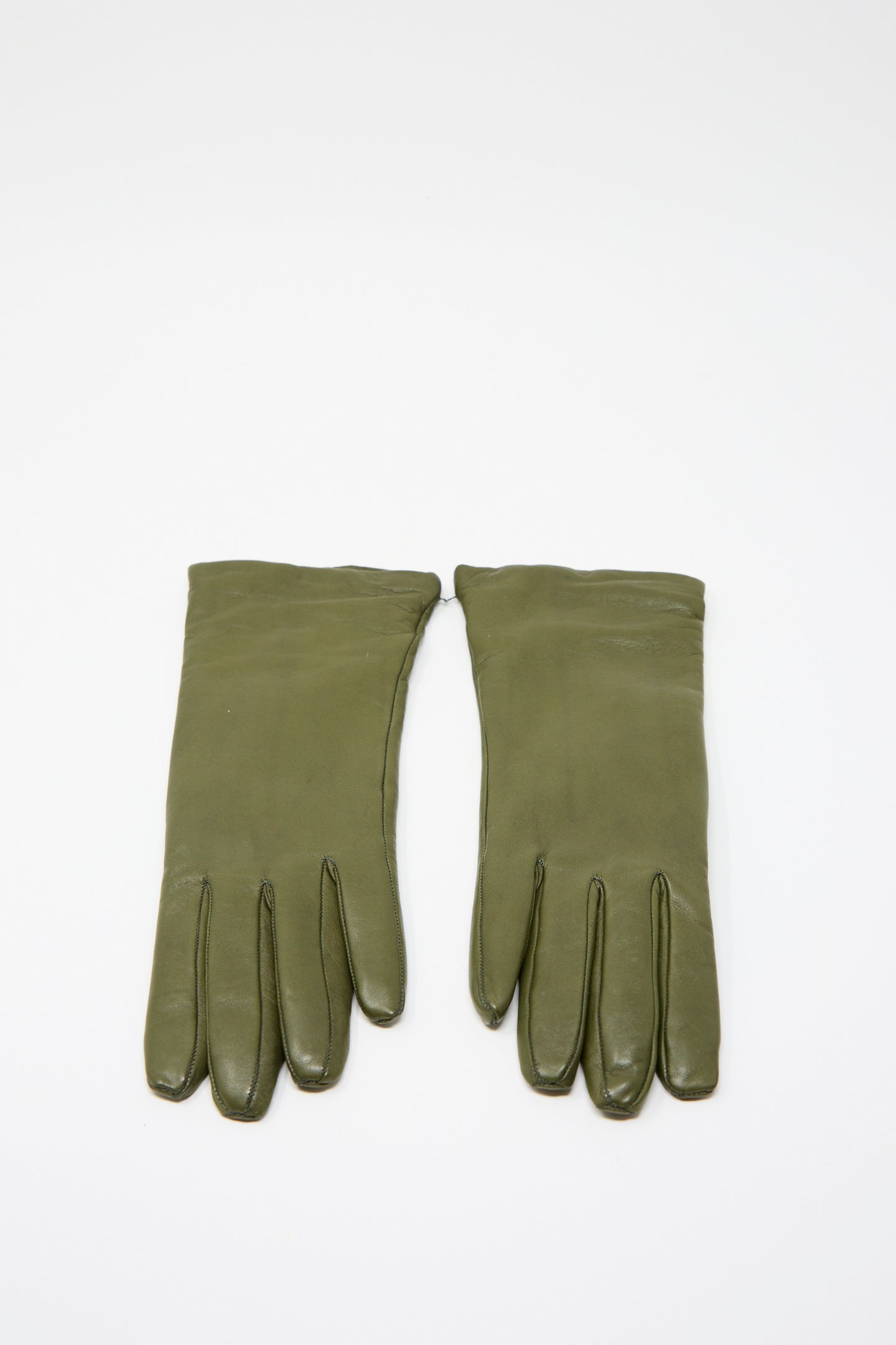 A pair of Clyde's Lambskin and Cashmere Classic Gloves in Bog Green, made and lined with cashmere, laid flat on a plain white background.