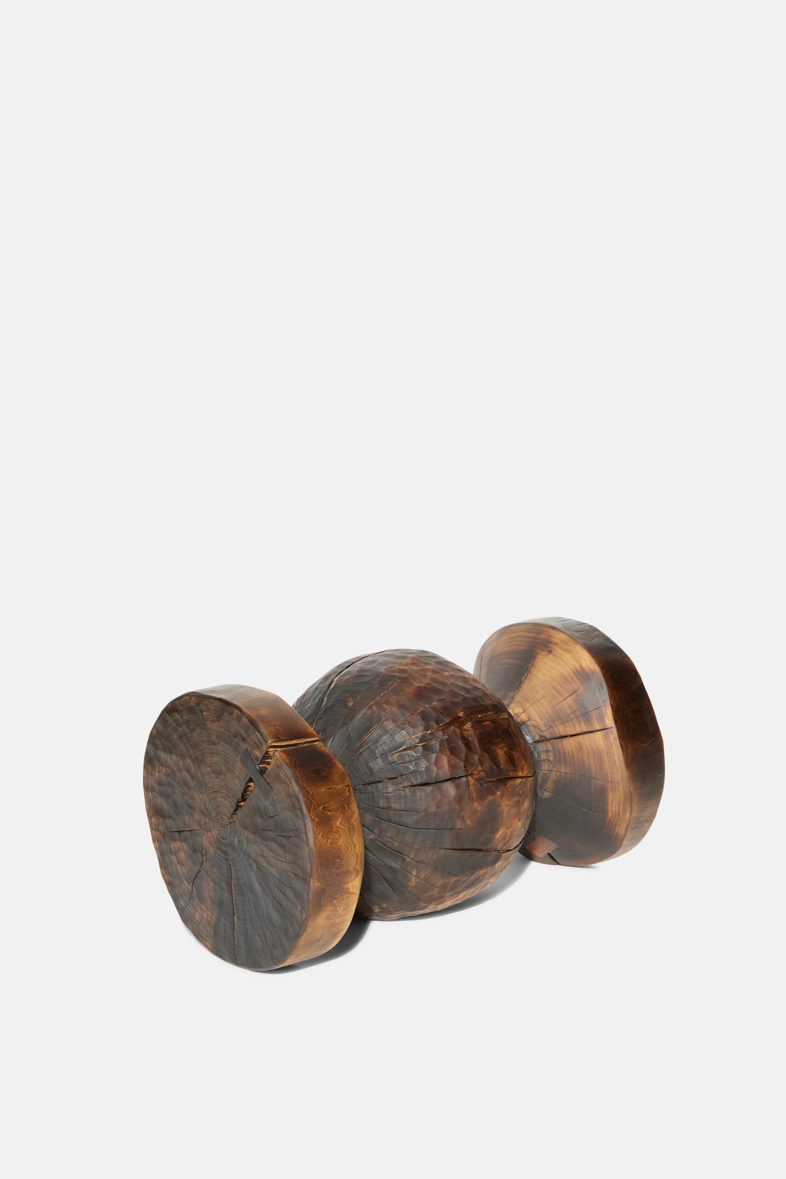 The Bon Bon Side Table by Cody Brgant is a handmade, dark polished wooden piece with three cylindrical sections, crafted in Brooklyn and featuring visible grain and cracks.