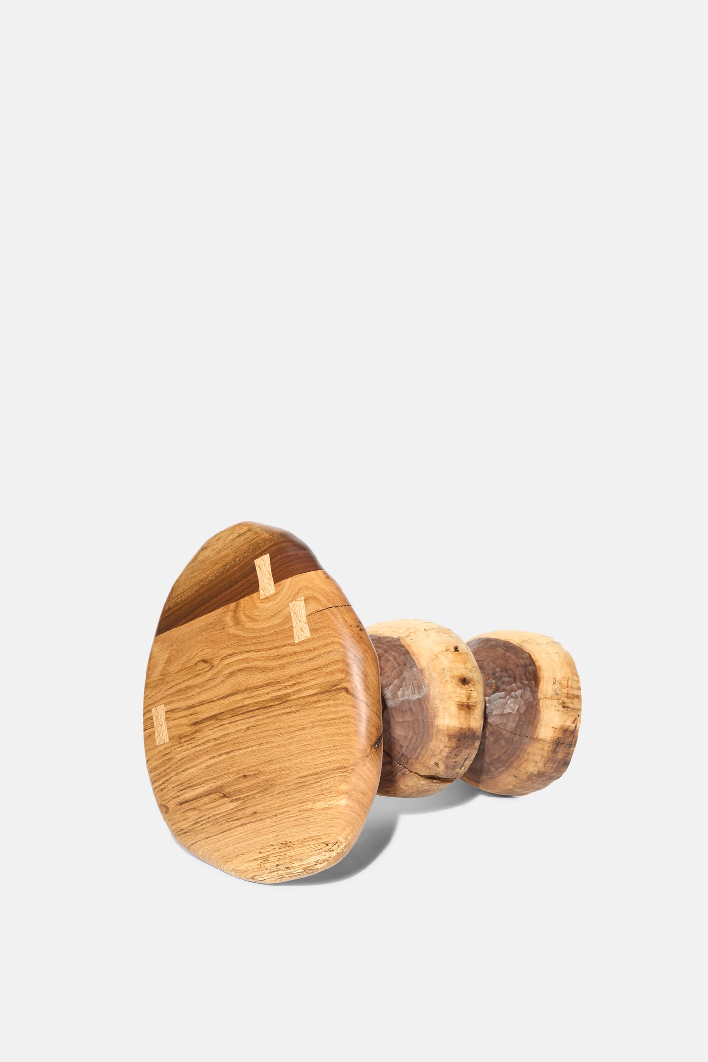 The Bon Bon Side Table with Top by Cody Brgant is a handmade, mushroom-shaped stool crafted in Brooklyn from black walnut, featuring a round base and textured grain, shown against a plain white background.
