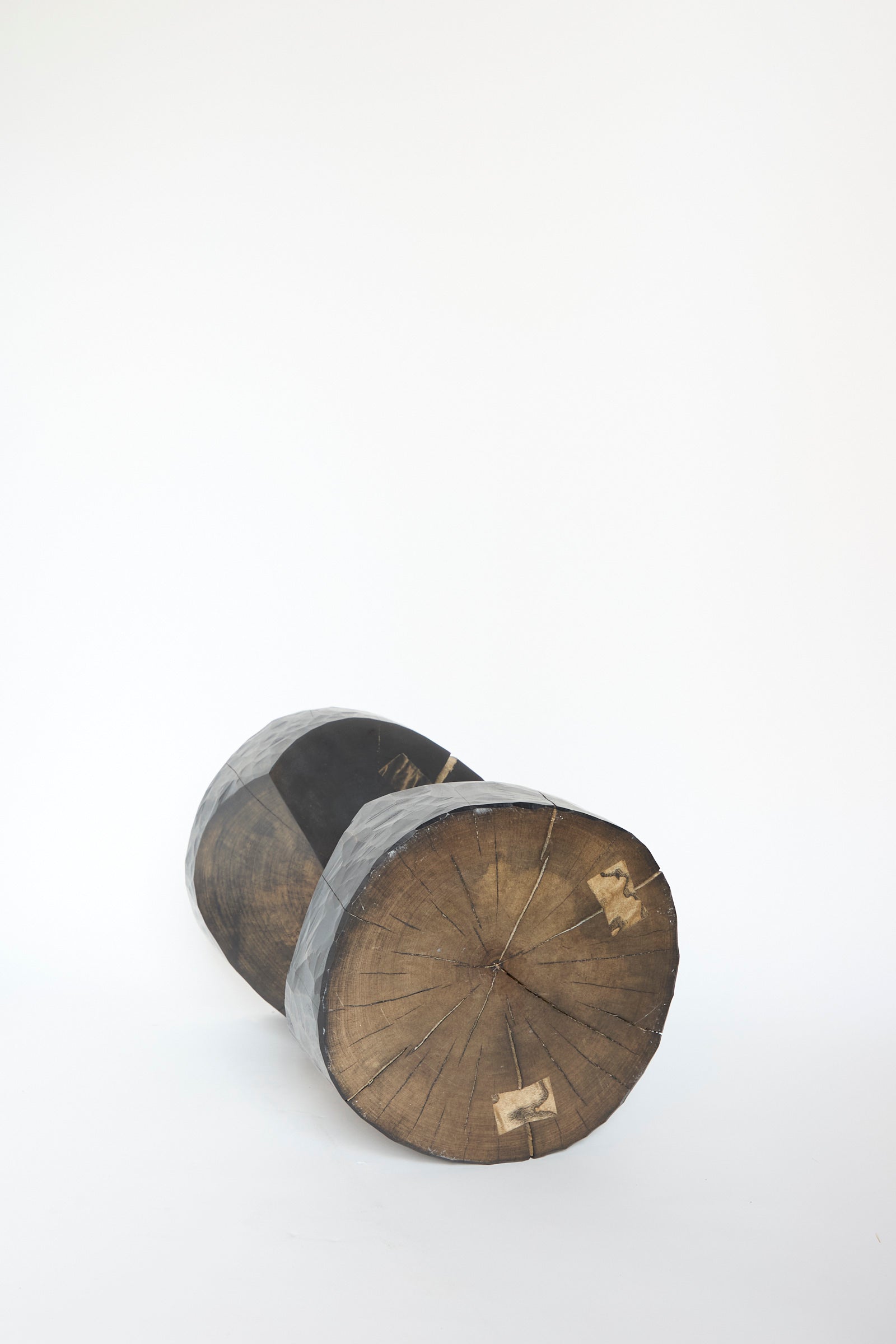 A Windsor Terrace Sycamore Side Table with Oak Inlay by Cody Brgant, featuring a textured surface reminiscent of a natural wooden log, is  set against a plain white background, revealing it's front facing view. 