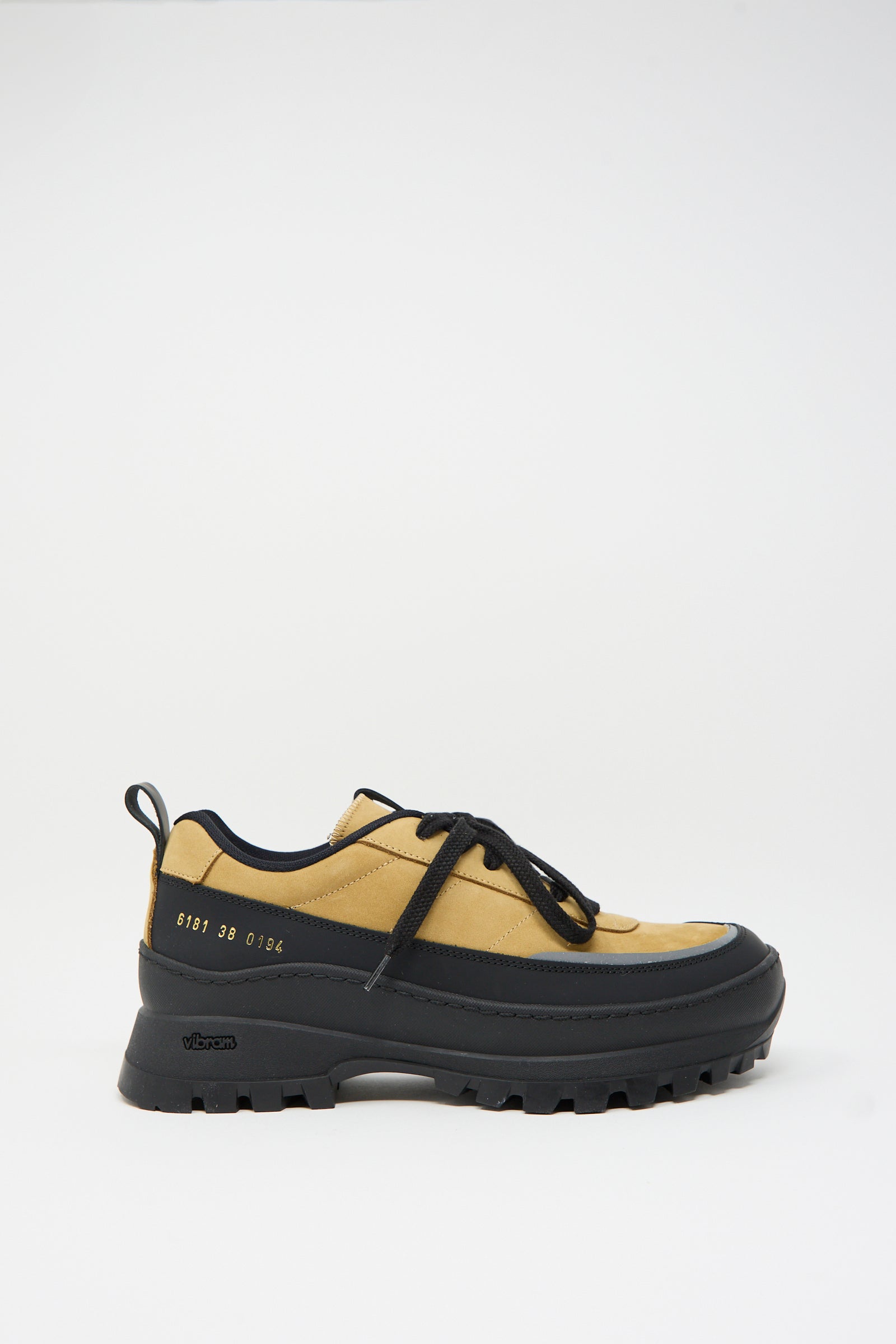 A single Common Projects Track Hiker low-top sneaker (Article 6181) in Ocra, featuring black laces, a thick rugged Vibram sole, and the number 6191 38 0164 printed on the side against a plain white background.