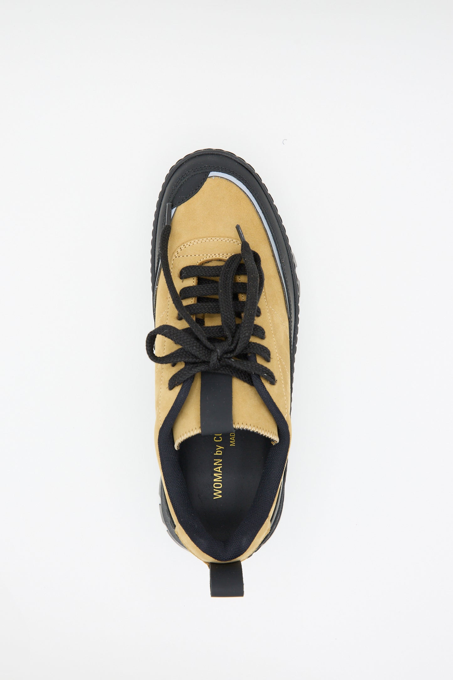 Top-down view of a single tan and black athletic shoe with black laces and a thick Vibram sole, perfect for the chunky track hiker. The inner label reads "WOMAN GL". This is the Track Hiker Article 6181 in Ocra by Common Projects.