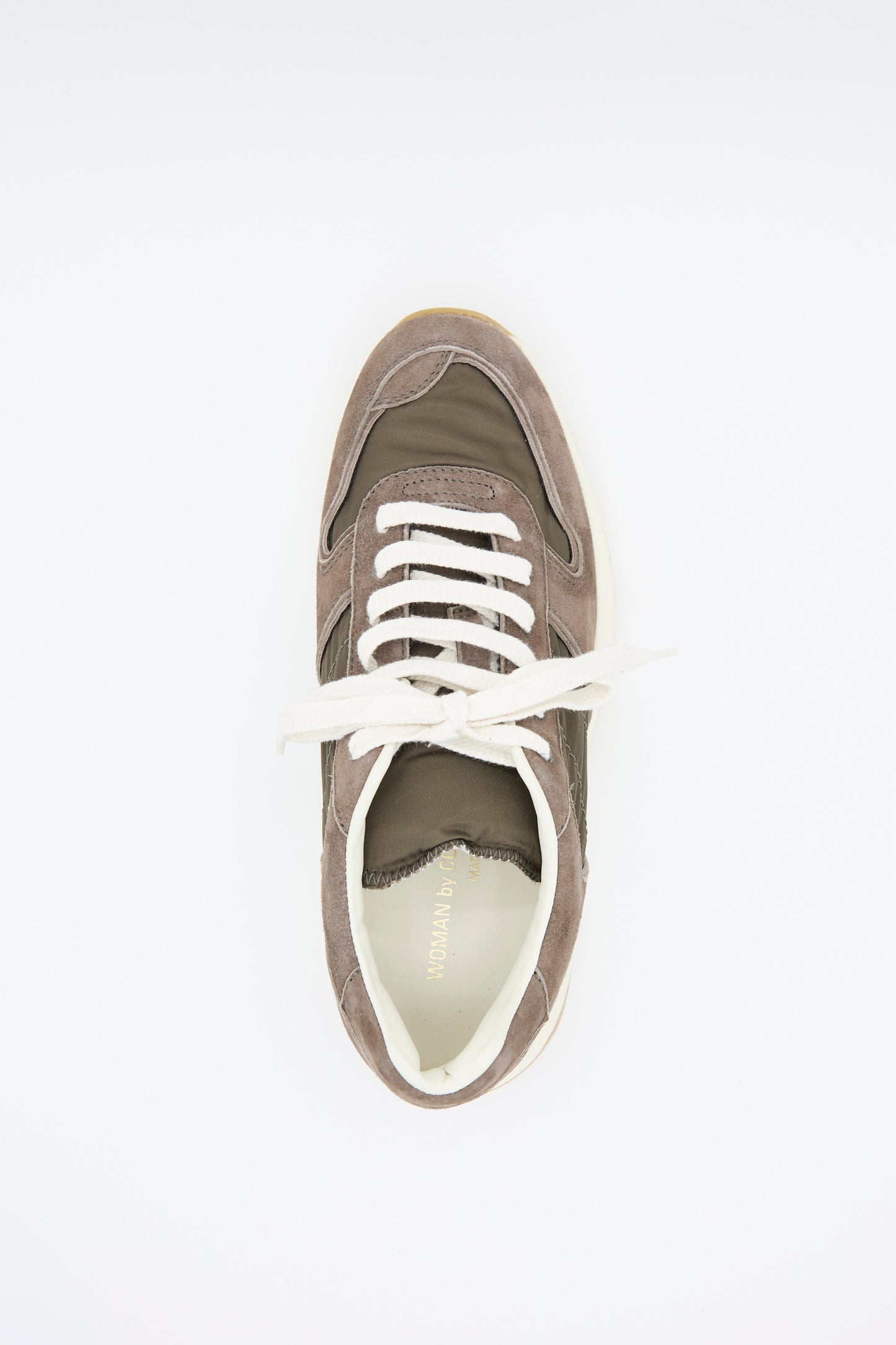 Top view of Common Projects' Track Premium Article 6171 in Coffee, showcasing a classic design with white laces and a cushioned footbed, set on a plain white background.