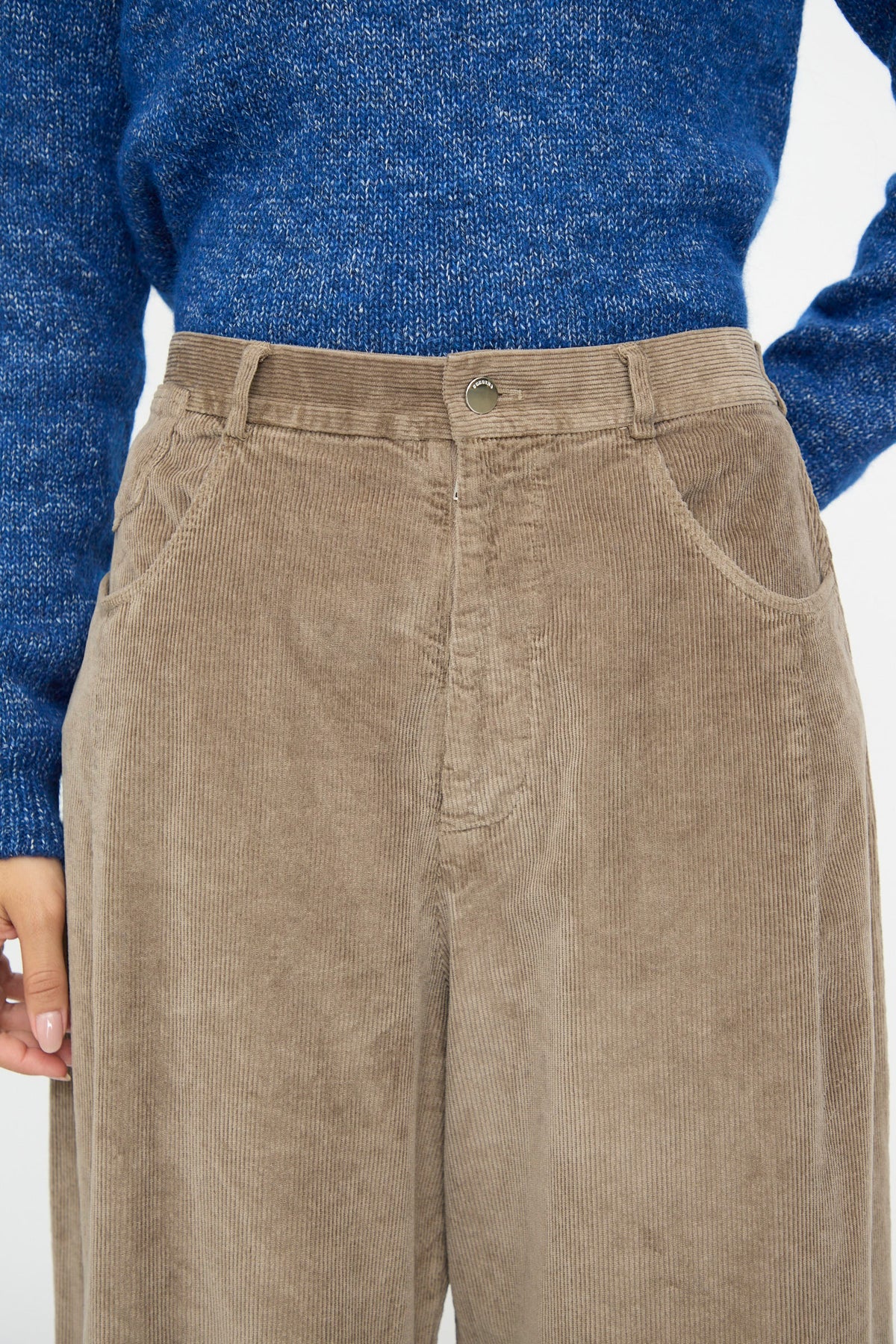 Cordera Corduroy Baggy Pants in Sage, featuring a high-waisted baggy fit with side pockets and an elastic waistband, worn with a blue textured sweater.