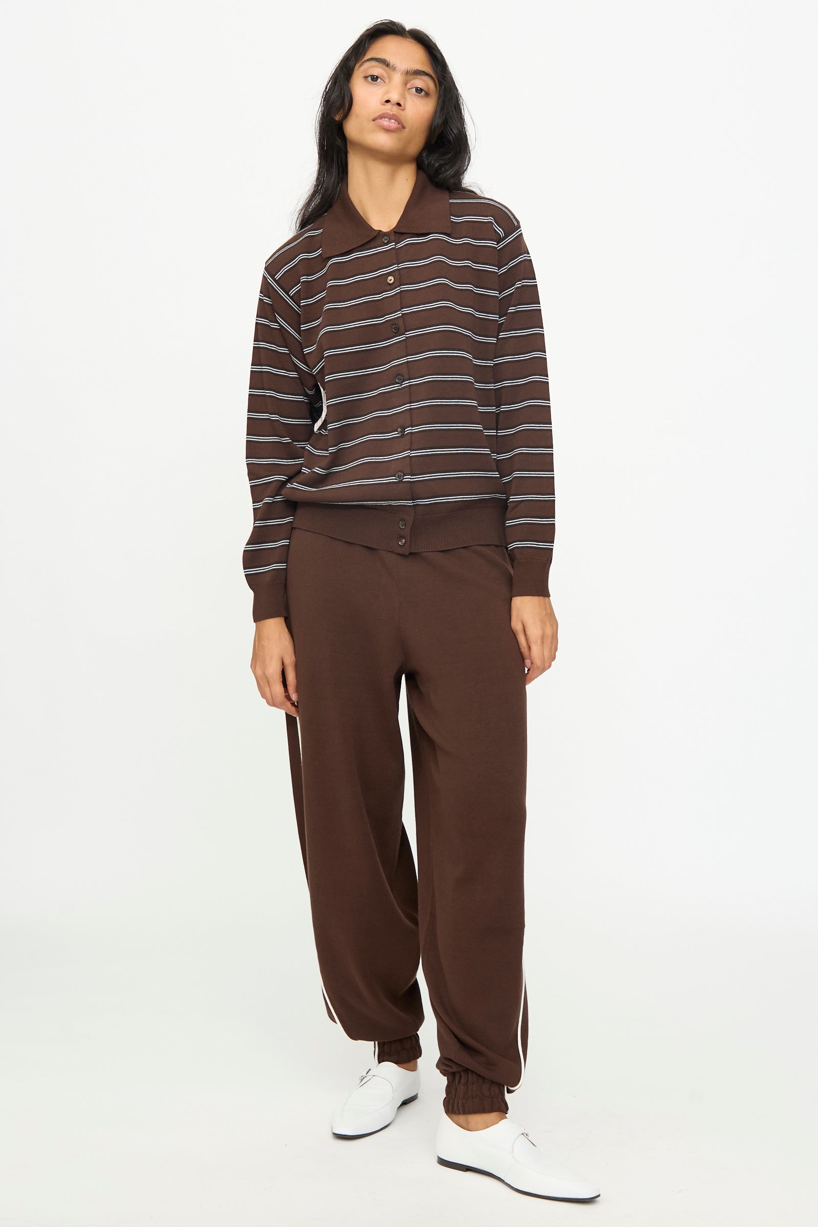 A person is wearing the Cordera Cotton Polo Cardigan in Striped along with matching brown pants and white shoes, standing against a plain white background.