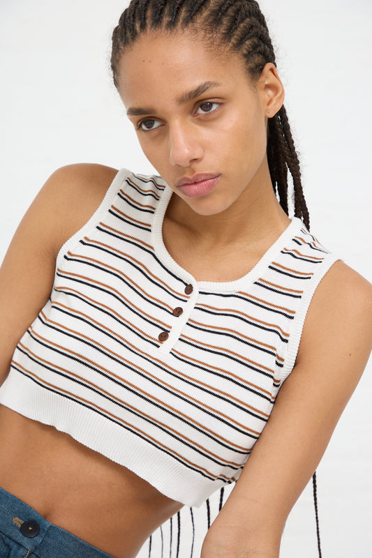 Young woman with braided hair wearing a Cordera Organic Cotton Top in Striped and jeans.