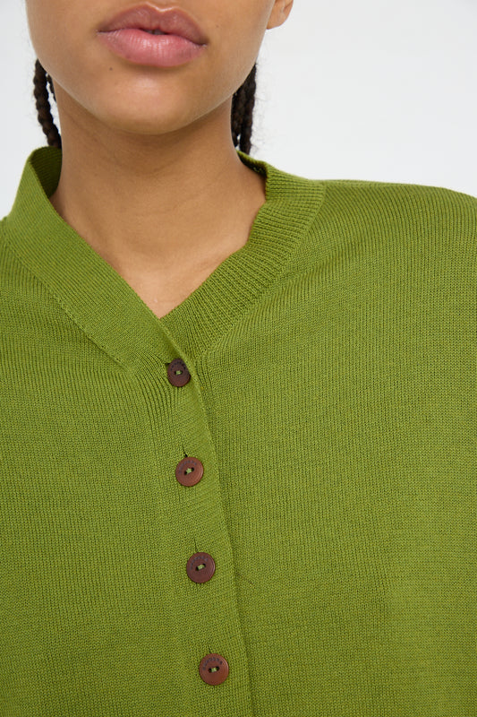 A close-up of a person wearing a Woodbine Cotton and Cashmere Cardigan by Cordera.