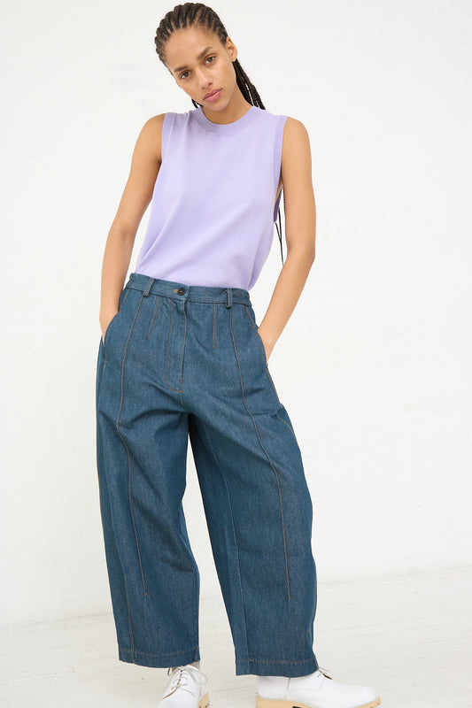 Woman wearing a lavender sleeveless top and Cordera's Frontal Seam Curved Pant in Denim made from an ethically manufactured cotton/hemp blend.