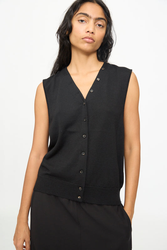 A person wearing the Cordera Merino Wool Button Waistcoat in Black and black pants stands against a plain white background, looking at the camera with a neutral expression.