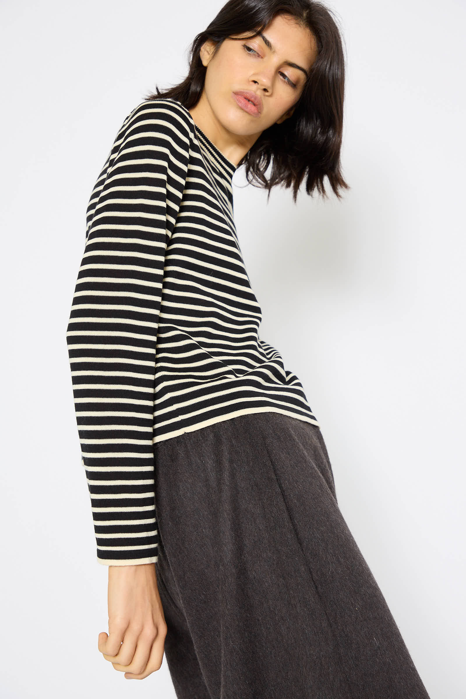 A person in a Cordera Organic Cotton T-Shirt in Striped and dark trousers poses against a plain white background.