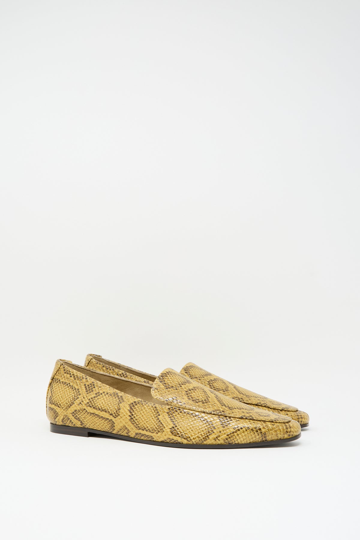 Cordera Pointy Loafer in Snake featuring pointy-toe loafers in snake-embossed leather with a yellow and brown pattern and low heels.