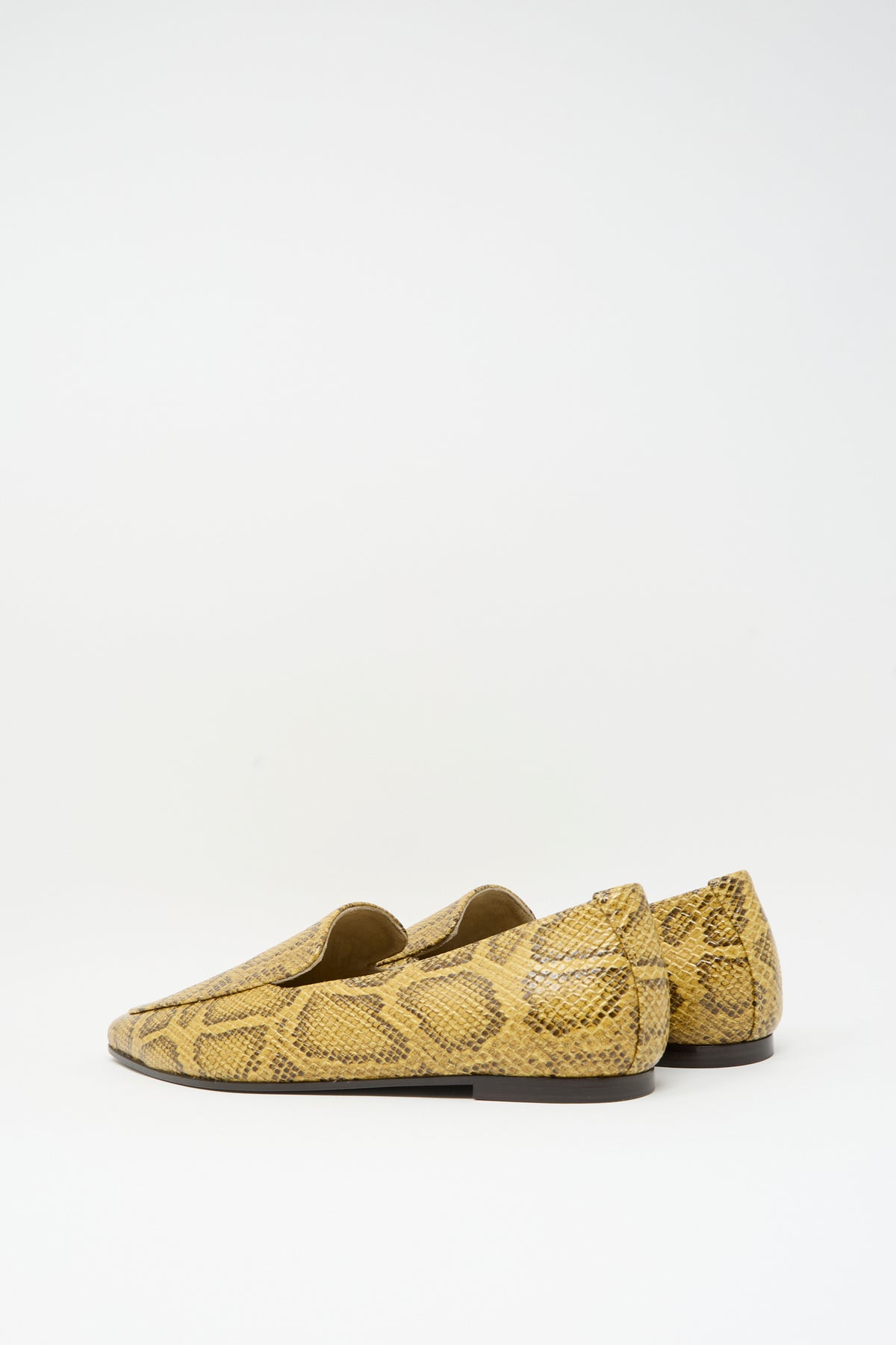 Cordera Pointy Loafer in Snake: a pair of pointed-toe loafers in snake-embossed leather with a yellow and brown snakeskin pattern.