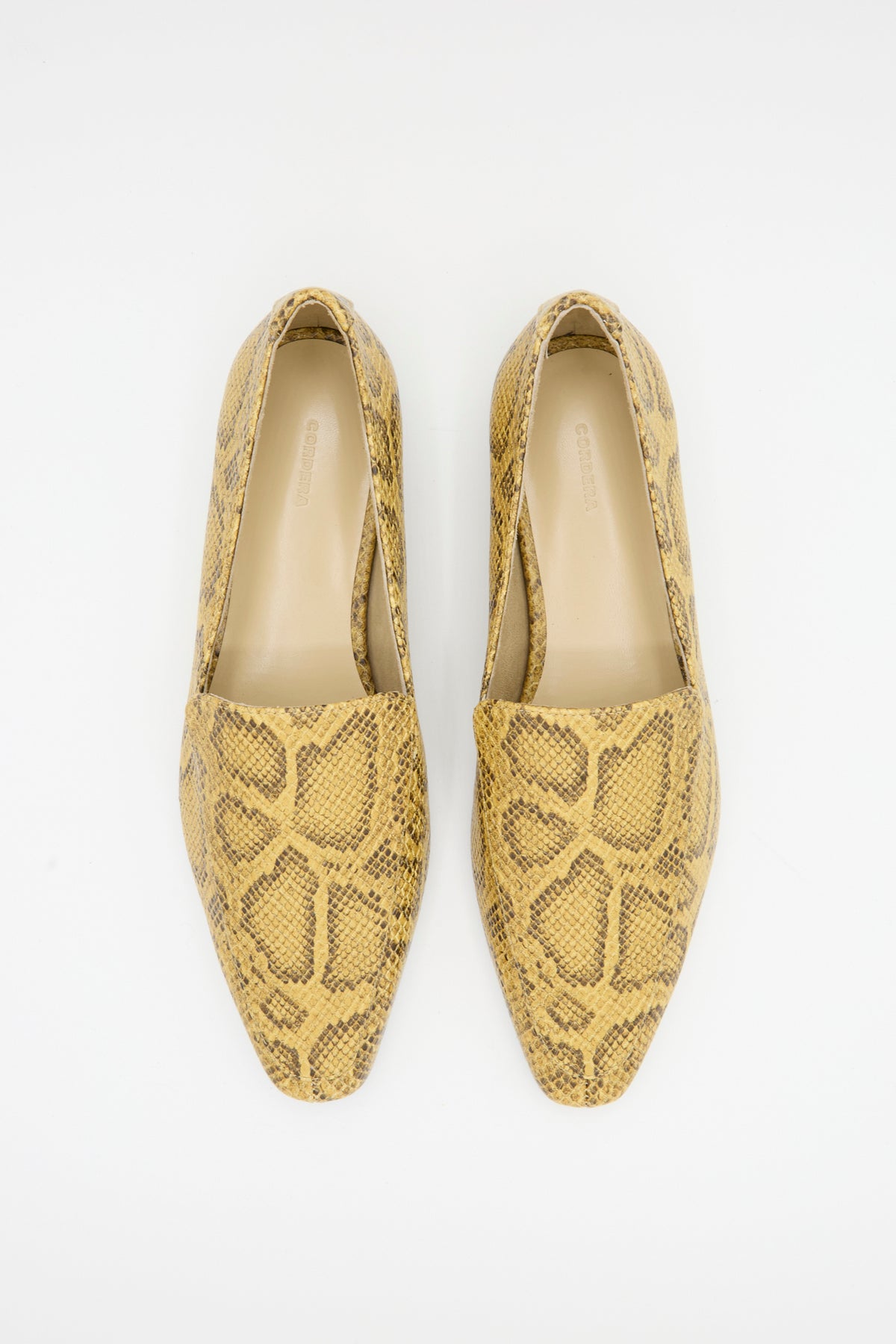 Cordera Pointy Loafer in Snake: pair of tan and brown snake-embossed leather pointed-toe loafers.