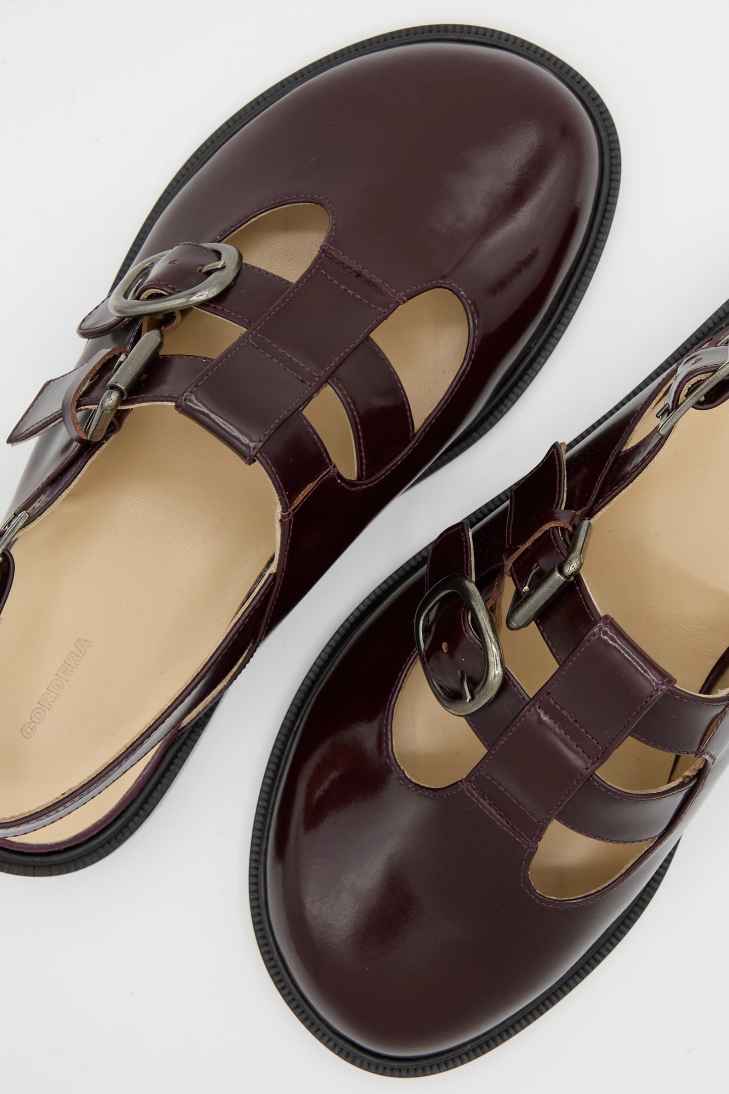 Slingback Mary Jane leather sandals in burgundy by Cordera, featuring cut-out designs and double buckle closures, viewed from above.