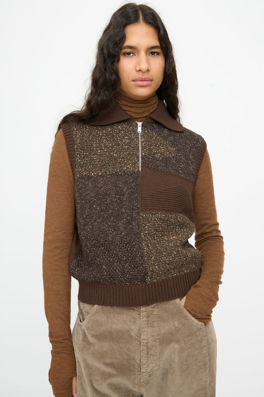 A person wearing a brown Cordera Speckled Waistcoat in a zip-up patchwork wool blend over a brown turtleneck.