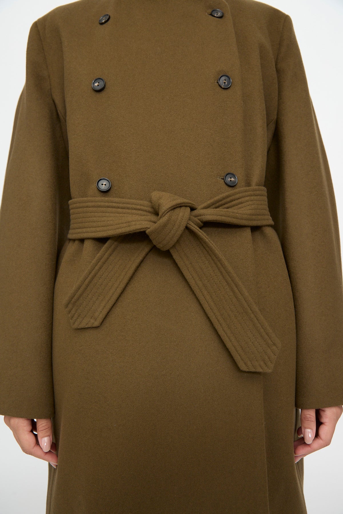 Cordera Virgin Wool Long Coat in Pardo, an olive green oversized wool coat with a mandarin collar, double-breasted and tied at the waist with a matching fabric belt.