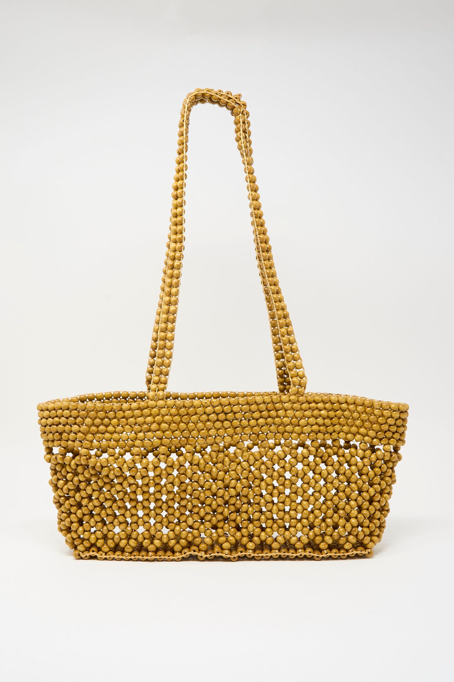 The Cordera Wooden Beads Mini Bag in Ochre features small round tan beads and two beaded shoulder straps, handmade in Guatemala and showcased against a plain white background.