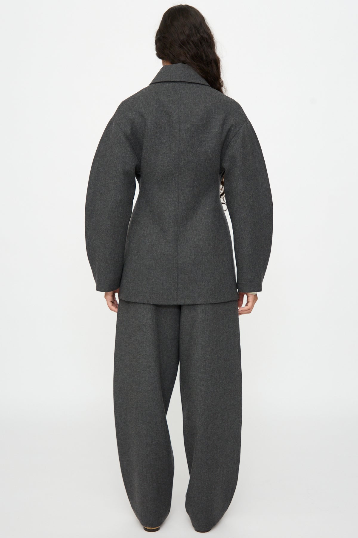 Back view of a person wearing a relaxed fit, grey Wool Overshirt in Grey overshirt and matching wide-leg trousers.