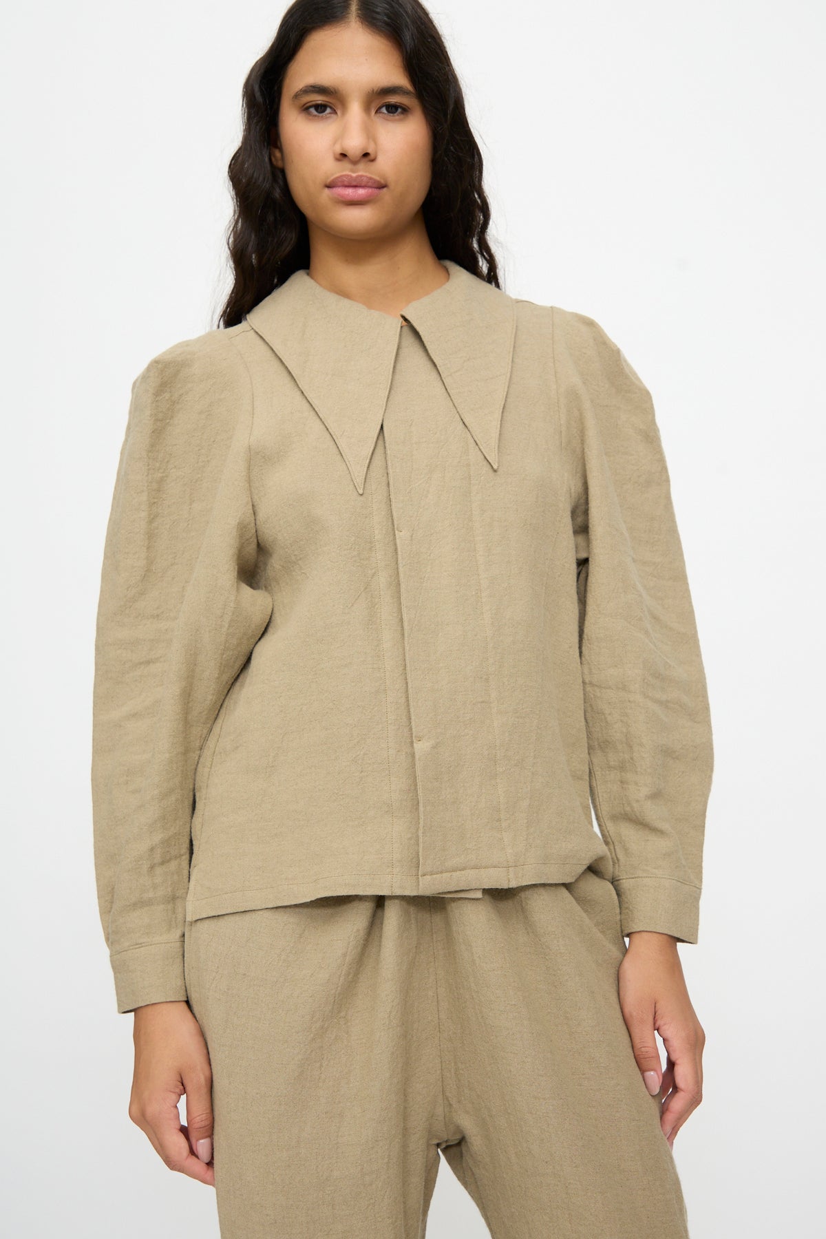 Person wearing a Cosmic Wonder Band Collar Shirt in Beige, featuring an oversized pointed collar and a hidden button placket.