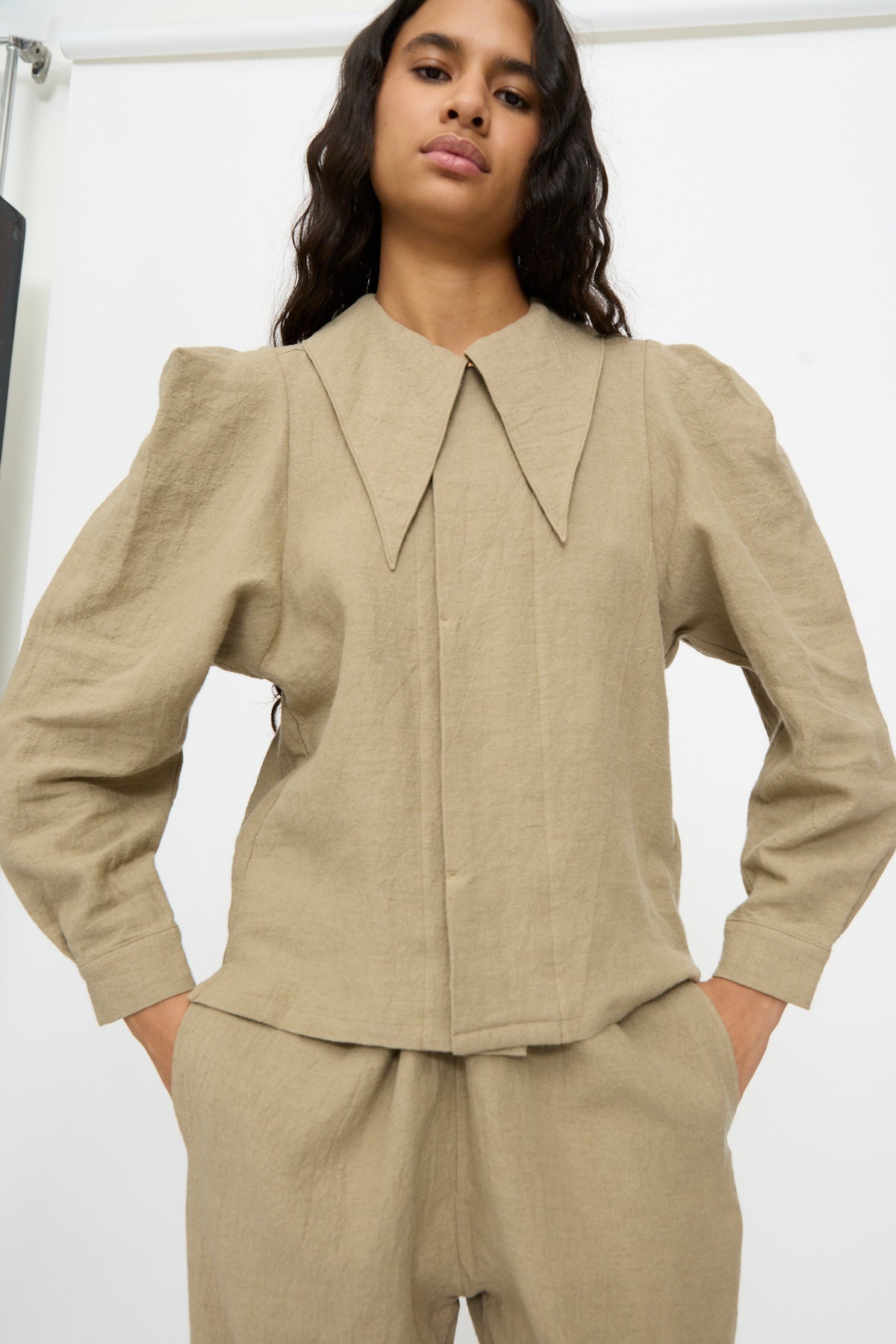 Cosmic Wonder Band Collar Shirt in beige linen wool with a pointed collar and puff shoulders.