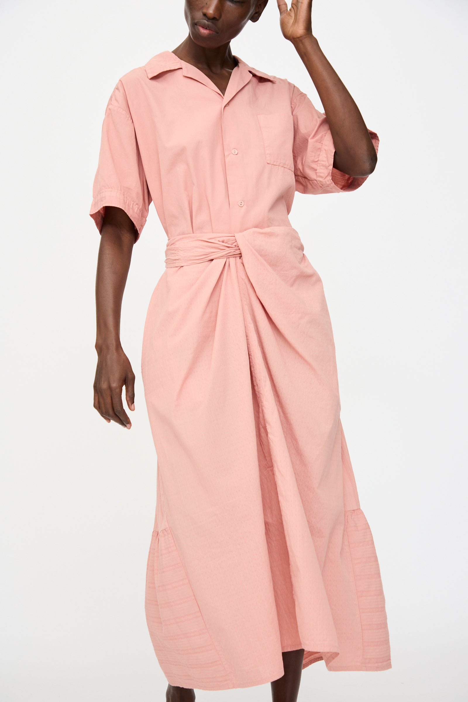 A person wears the Cosmic Wonder Stripe Combination Wrapped Skirt in Rose Crystal, featuring a knotted waist and organic cotton fabric, styled against a plain white background.