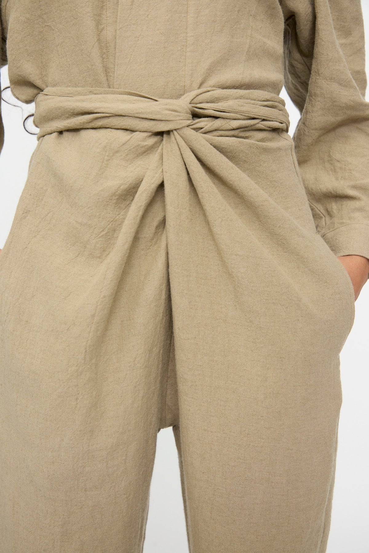 Cosmic Wonder Wrap Pants in Beige featuring a knotted waistband and side pockets.