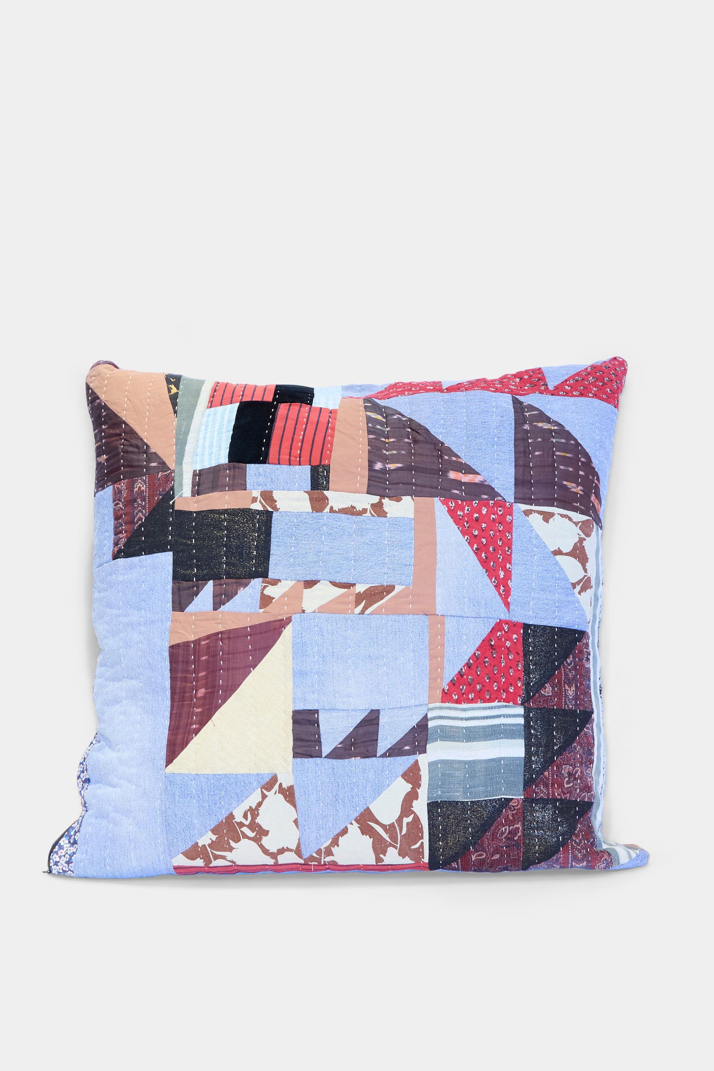 The Counterpane Patchwork Pillow in Denim and Terracotta Multi II features a geometric patchwork cover made from antique found cloth in blue, red, brown, black, and cream—crafted in California and shown on a plain white background.