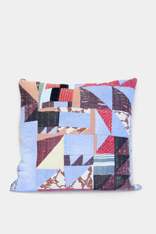 The Counterpane Patchwork Pillow in Denim and Terracotta Multi II features a geometric patchwork cover made from antique found cloth in blue, red, brown, black, and cream—crafted in California and shown on a plain white background.