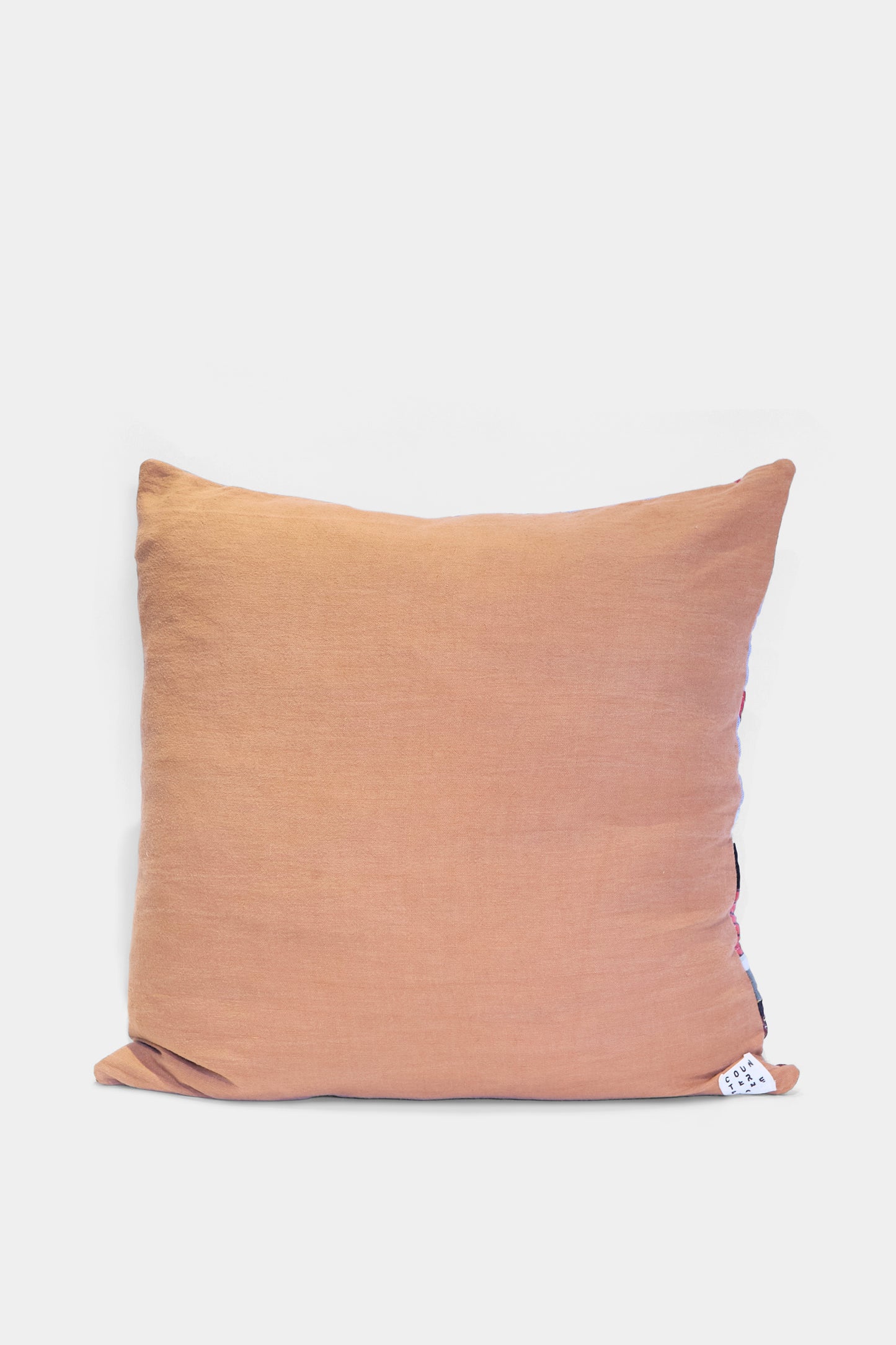 The Patchwork Pillow in Denim and Terracotta Multi II by Counterpane, crafted from antique found cloth with a fabric tag, is shown against a plain white background.