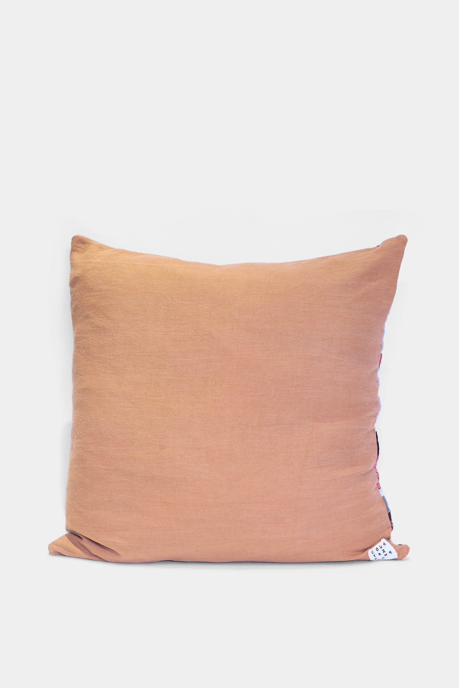 The Patchwork Pillow in Denim and Terracotta Multi II by Counterpane, crafted from antique found cloth with a fabric tag, is shown against a plain white background.