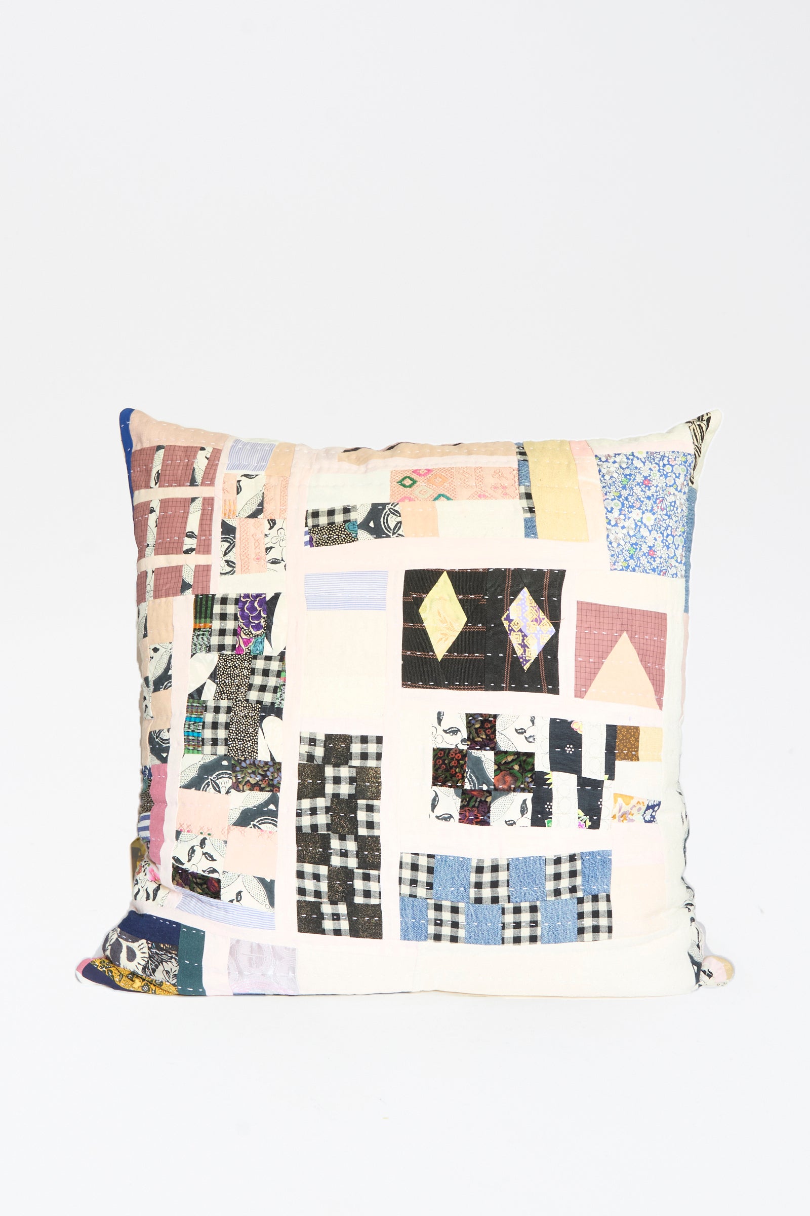 The Counterpane Patchwork Pillow 28" x 28" in Pink and Multi II features a quilted design with assorted patterns and colors, crafted from antique found cloth, and is displayed against a plain white background.