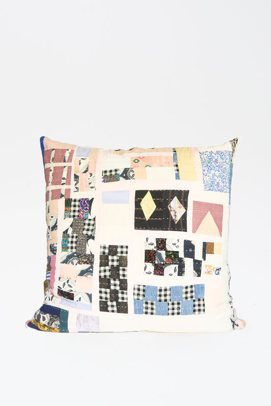 The Counterpane Patchwork Pillow 28" x 28" in Pink and Multi II features a quilted design with assorted patterns and colors, crafted from antique found cloth, and is displayed against a plain white background.