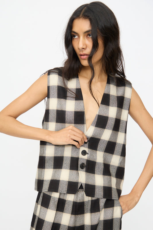 A woman wears the Cristaseya Button Down Vest in Black and Cream Checks with matching pants, standing against a plain white background.
