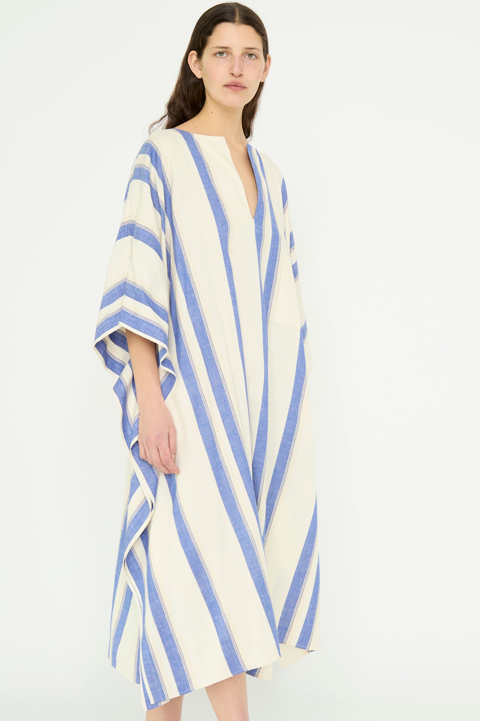 A model is wearing the Cotton Maxi Caftan in White with Blue Stripes by Cristaseya against a plain background.