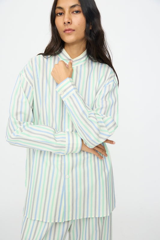 A person with long dark hair models the Cristaseya Handmade Fringed Mao Collar Shirt in Striped Pastel Green against a plain white background.