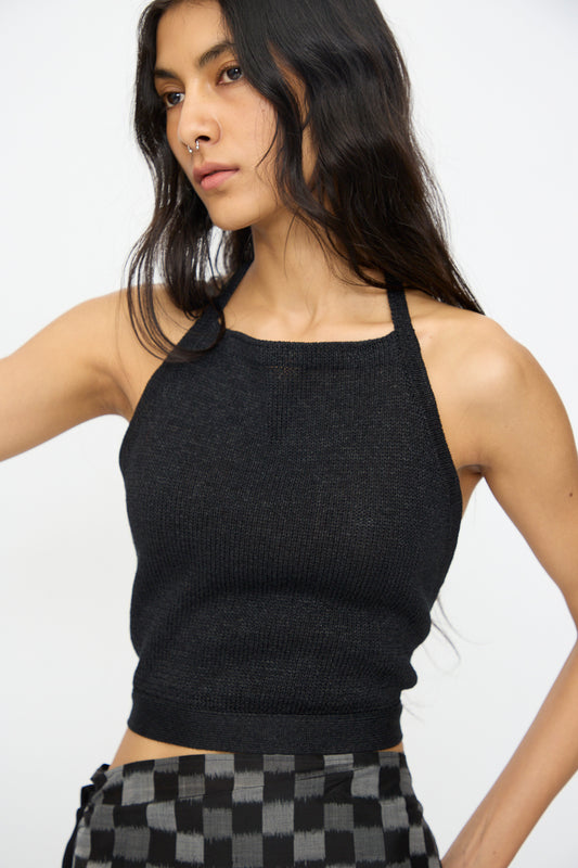 A woman with long dark hair wears the Cristaseya Washi Paper Summer Top in Black, paired with checkered pants, standing against a plain light background.