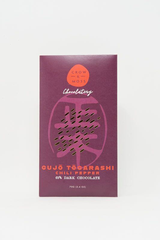 A 70g Crow & Moss Togarashi Chili Dark Chocolate Bar, made with single-origin Wampusirpi cacao, features a striking purple wrapper with orange text.