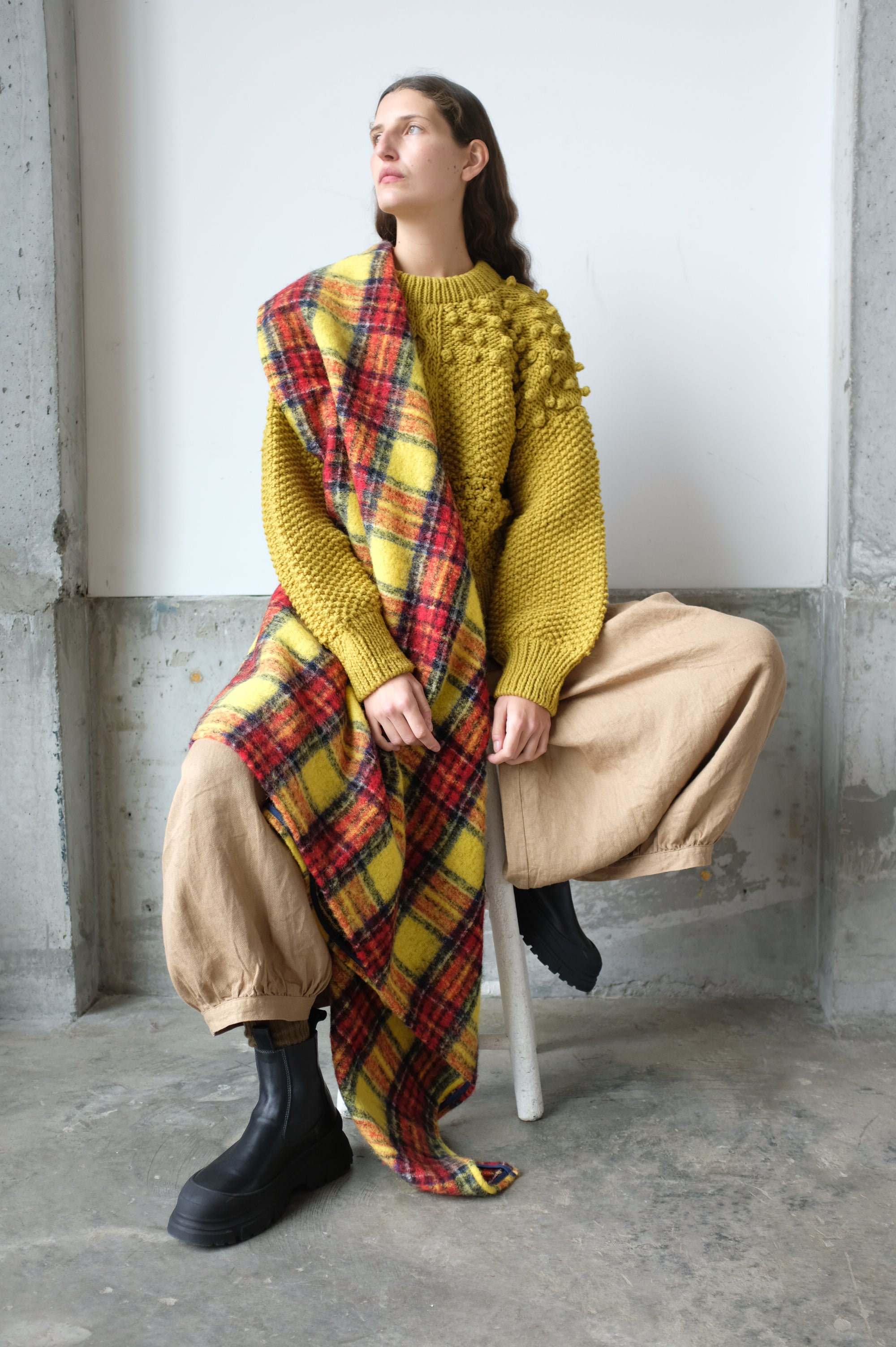 A model wearing the Wool Tartan Shaggy Stole in Yellow by Ichi Antiquités - Oroboro Store, New York, New York