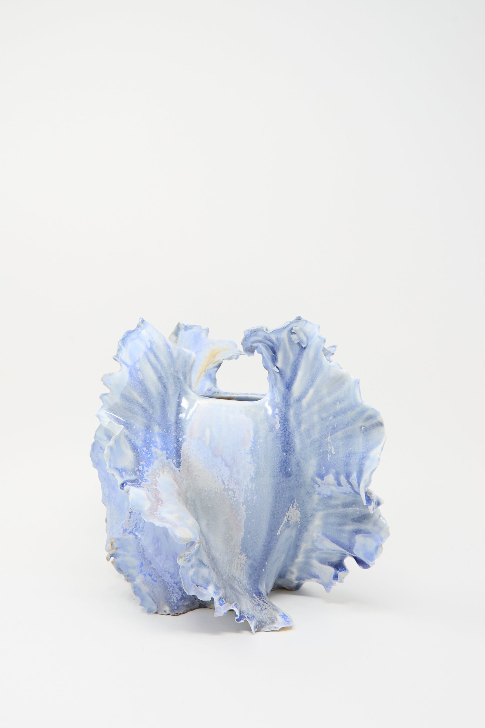 The Ash Bloom N.8 Woodfired in Blue by Dear You is a handmade ceramic vase with wavy, irregular edges and a glossy blue glaze reminiscent of coral, displayed against a plain white background.