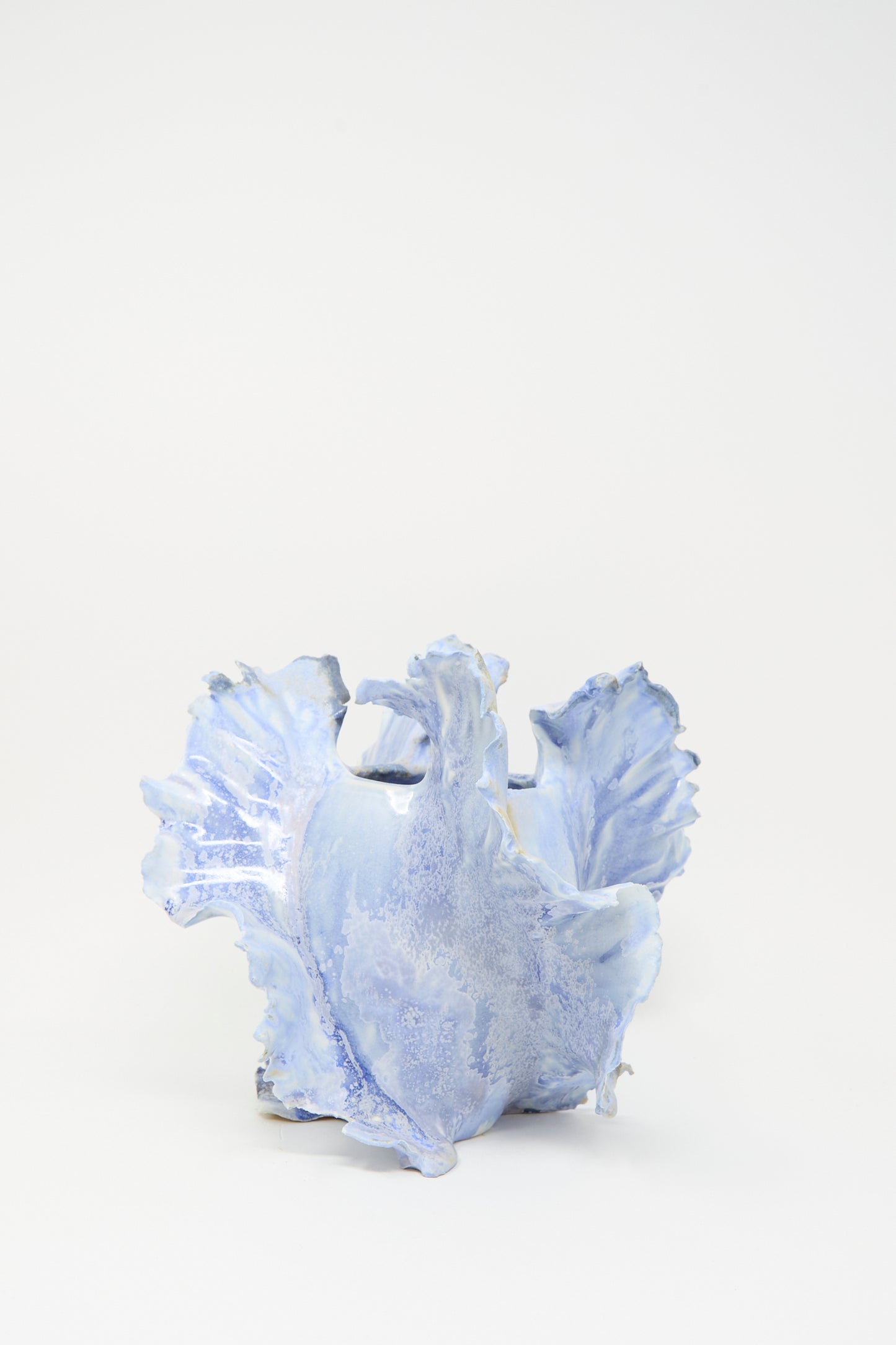 The Ash Bloom N.8 Woodfired in Blue by Dear You is a light blue porcelain vase with wavy, textured edges and a handmade feel, displayed against a plain white background.