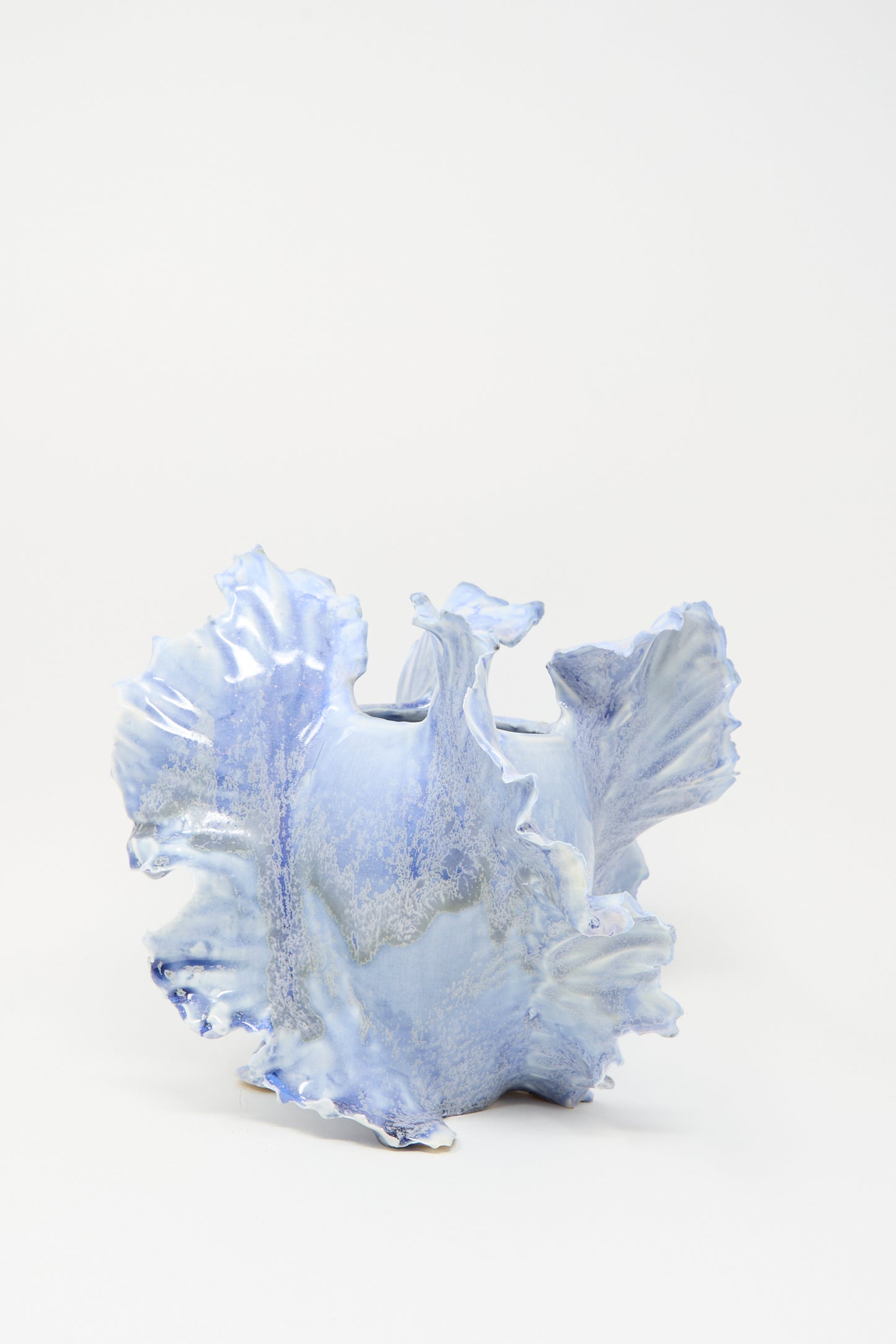 The Ash Bloom N.8 Woodfired in Blue by Dear You is a light blue ceramic vase with an irregular ruffled edge, organic sculptural form, and unique blue glaze, shown against a plain white background.