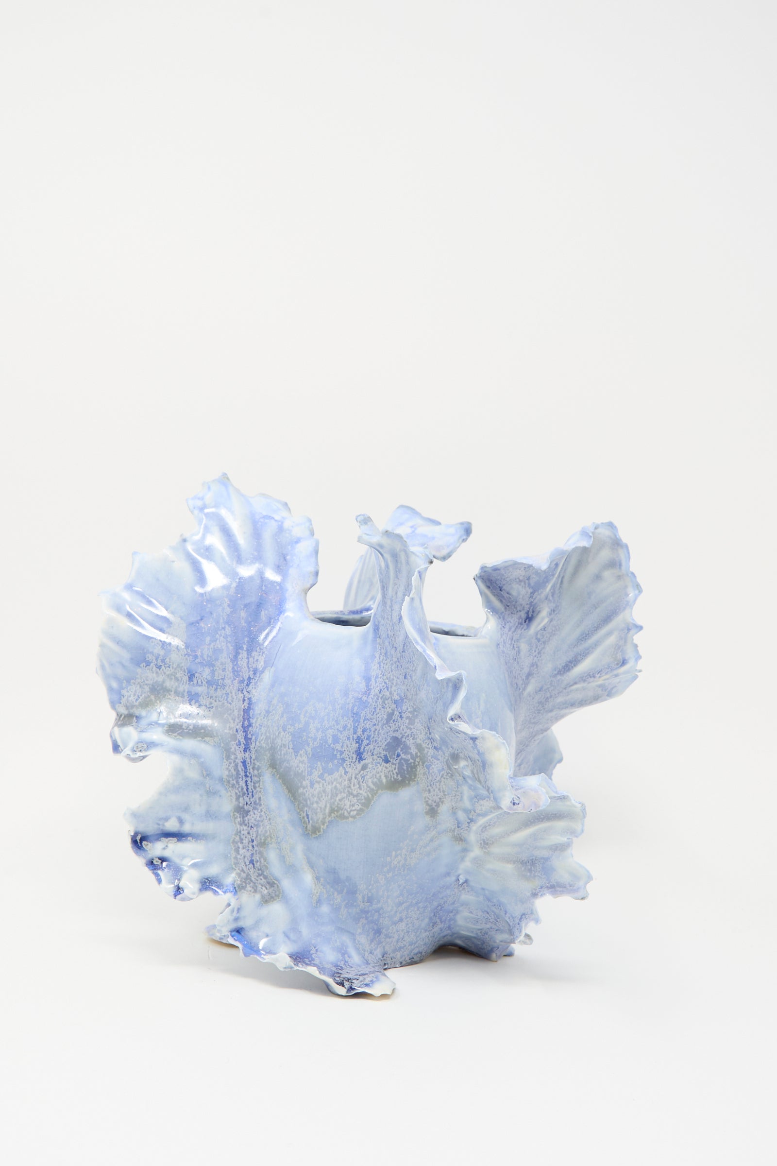 The Ash Bloom N.8 Woodfired in Blue by Dear You is a light blue ceramic vase with an irregular ruffled edge, organic sculptural form, and unique blue glaze, shown against a plain white background.