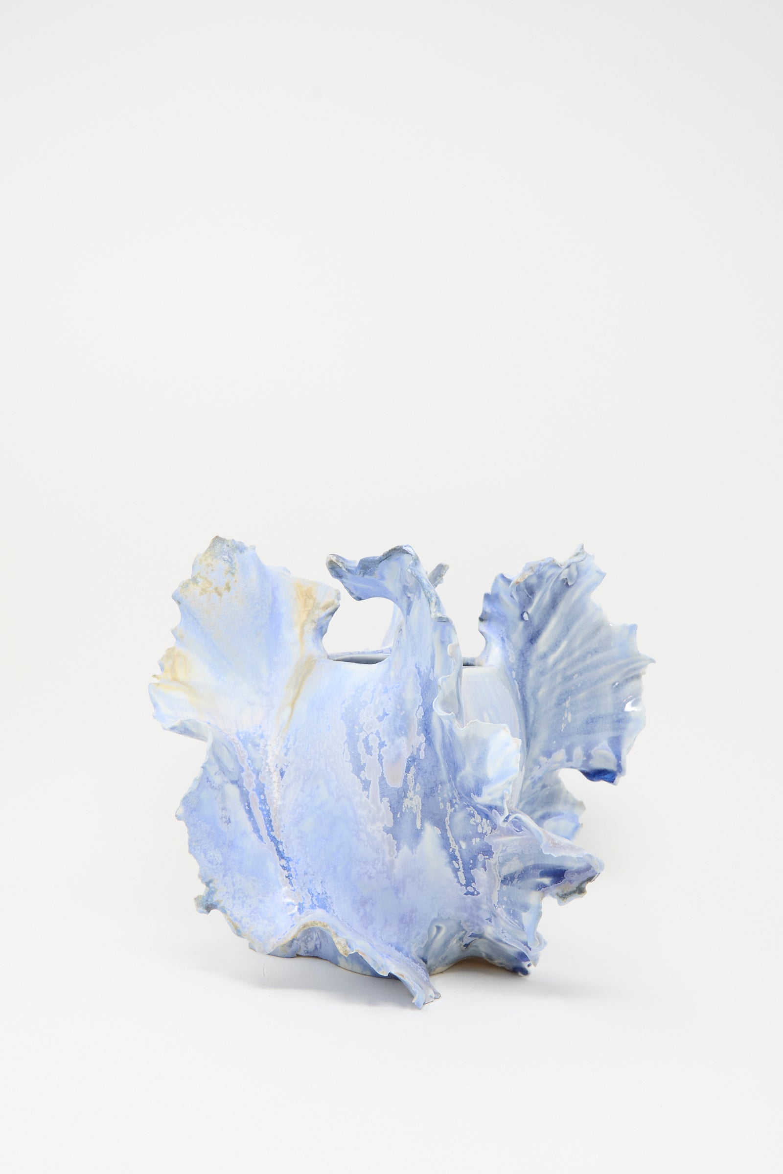Ash Bloom N.8 Woodfired in Blue by Dear You is a handmade ceramic sculpture with ruffled, organic edges in light blue and white, finished with a delicate blue glaze and set against a plain white background.