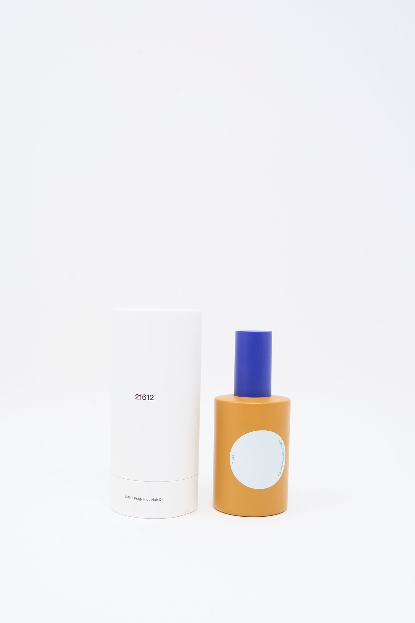 A white cylindrical container labeled "21612" stands next to a yellow bottle with a blue cap and a blank light blue label—identified as Diffar's Woody Earthy Fragrance Oil—both set against a clean white background.
