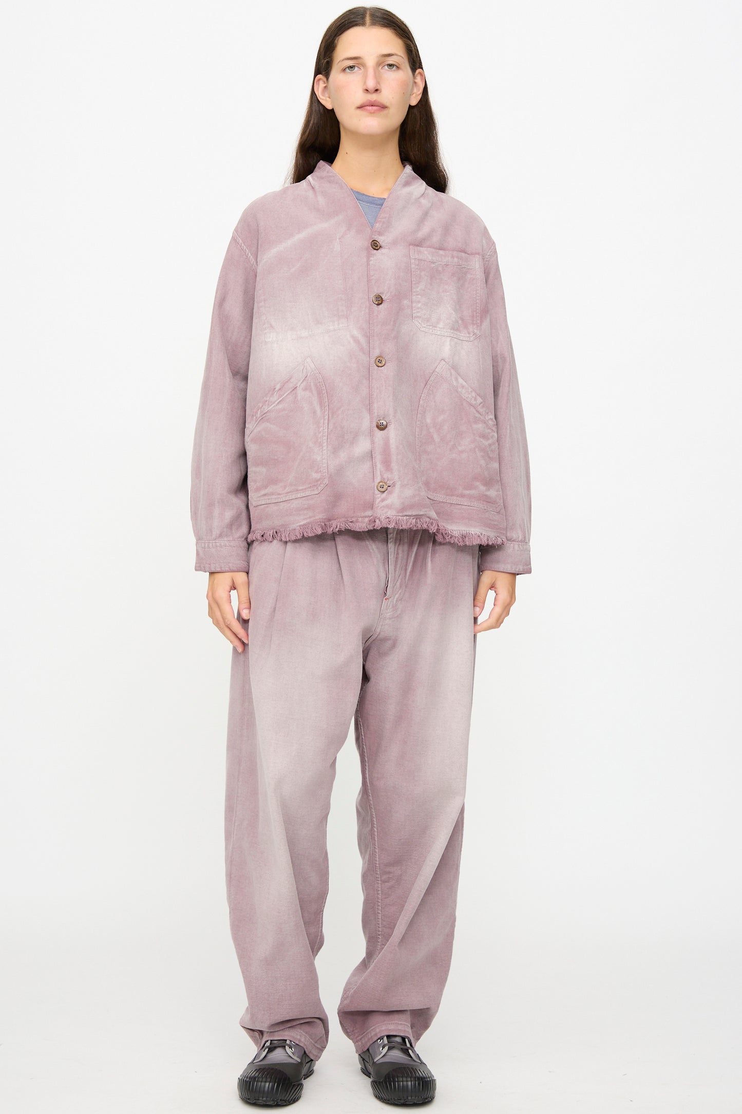 A person stands facing forward against a plain white background, wearing the Dr. Collectors 9 oz. Okinawa Jacket in Sunfaded Dusty Orchid—a loose-fitting, button-up vintage kimono jacket crafted from a linen cotton blend—with matching pants and black shoes.