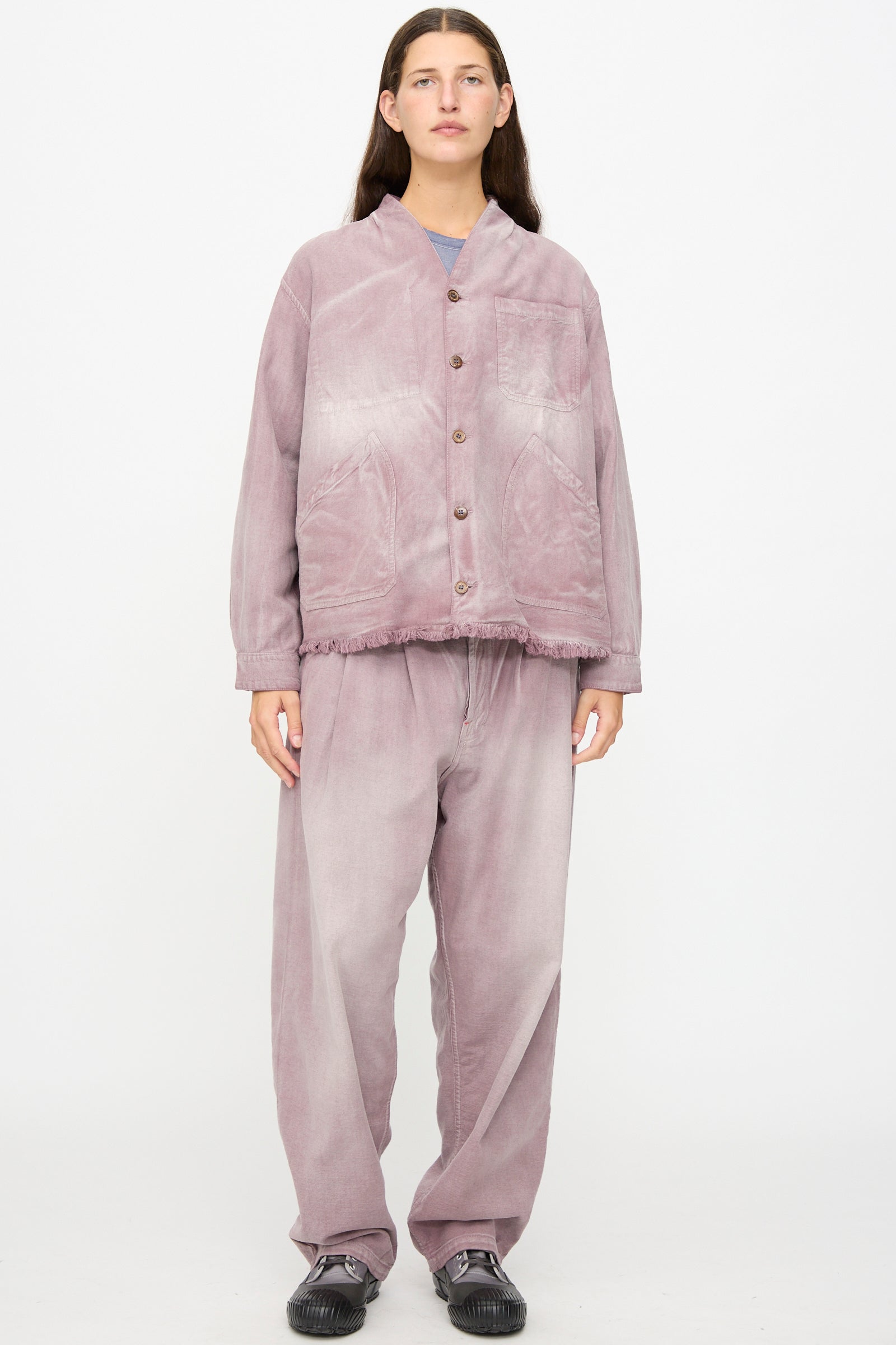 A person stands facing forward against a plain white background, wearing the Dr. Collectors 9 oz. Okinawa Jacket in Sunfaded Dusty Orchid—a loose-fitting, button-up vintage kimono jacket crafted from a linen cotton blend—with matching pants and black shoes.
