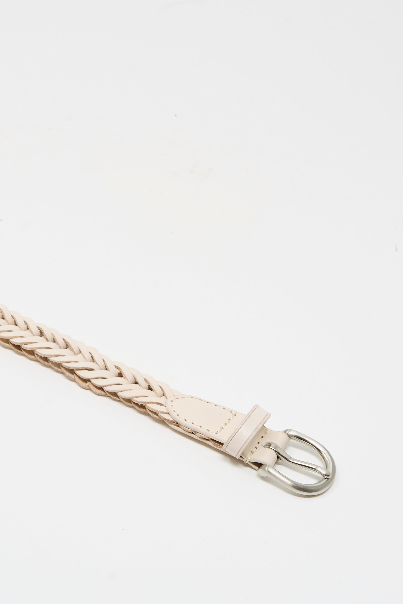 A close-up of the Dragon Diffusion Brass Buckle Single Link Belt in Sand, showcasing its handcrafted braided leather and bold brass buckle on a plain white background.