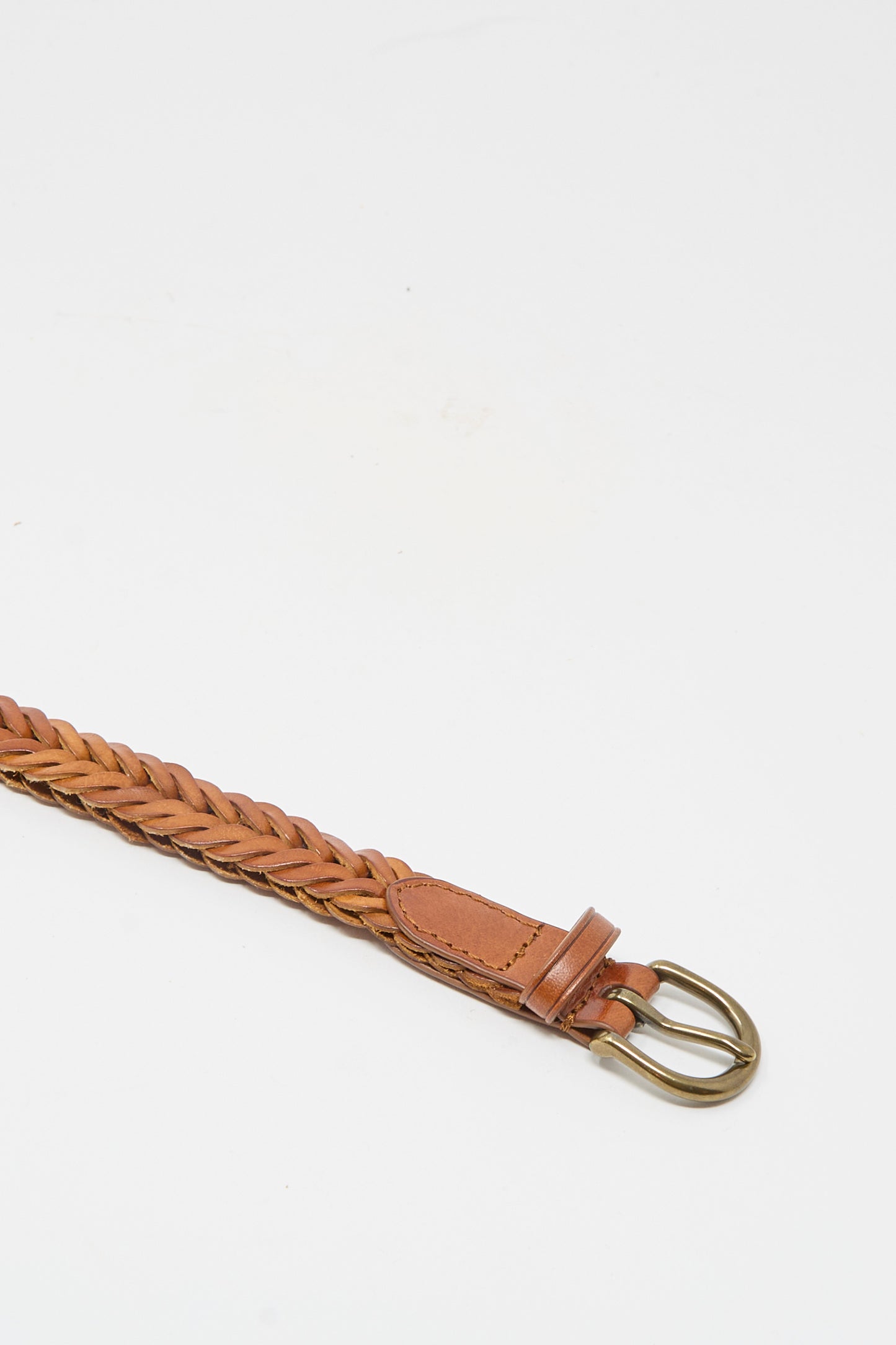 The Dragon Diffusion Brass Buckle Single Link Belt in Tan features a handcrafted braided leather design with a brass buckle, displayed on a plain white background.