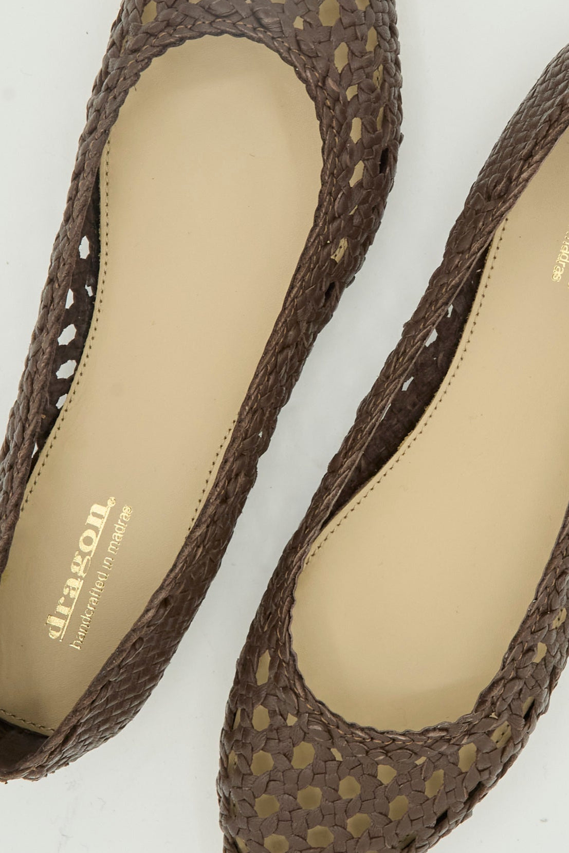 Close-up of the Capri Ballerina in Dark Brown by Dragon Diffusion, featuring woven goat leather, beige insoles, and the "dragon handmade in Madrid" logo printed in gold inside.
