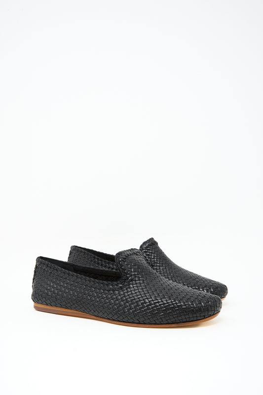 The Dragon Diffusion Damas Slipper in Black features handwoven leather and flat brown soles, shown against a plain white background.